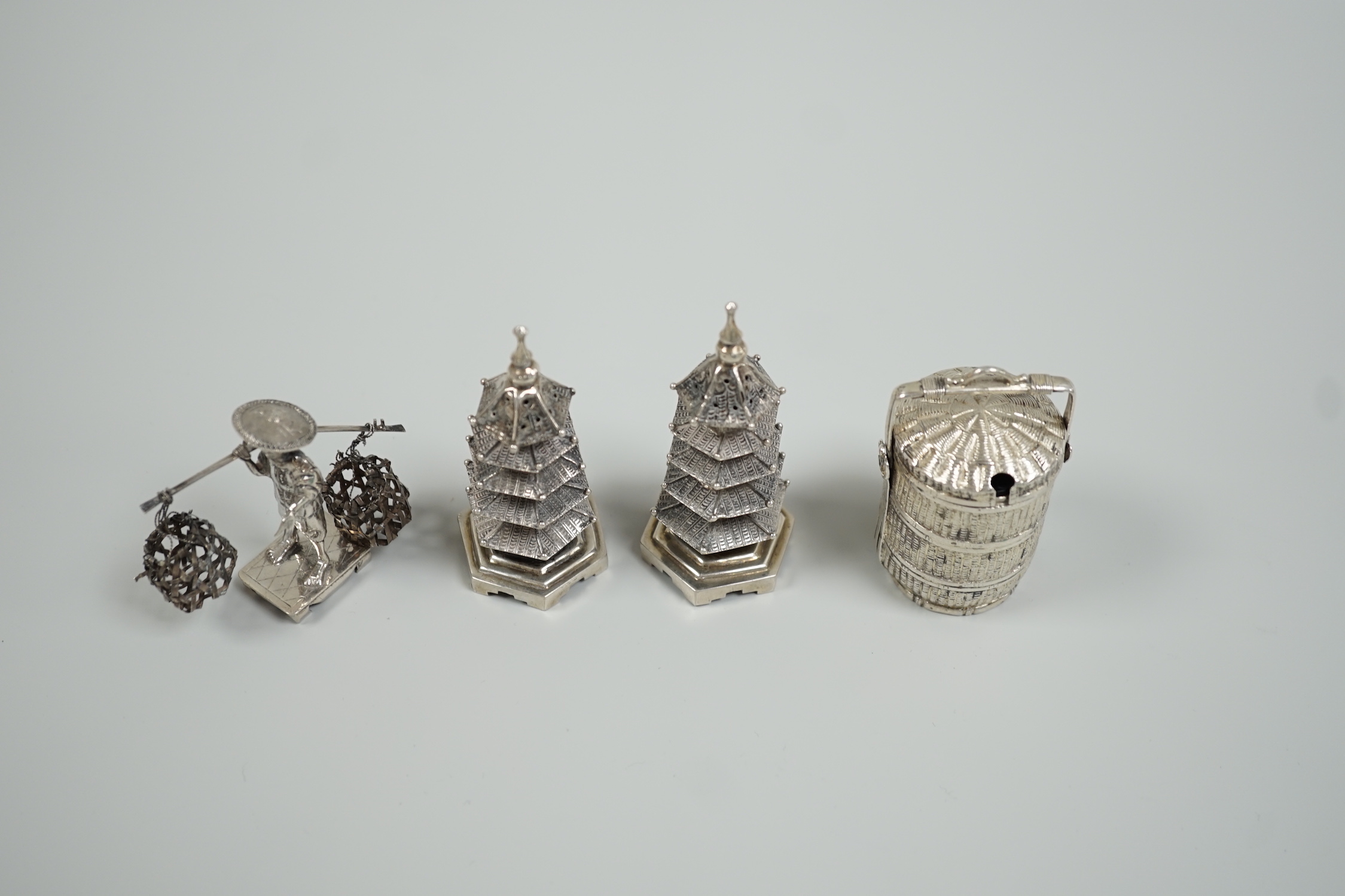 A Chinese white metal 'wedding basket' by Wang Hing, 63mm, a pair of similar white metal pagoda condiments, KSM and a figure.